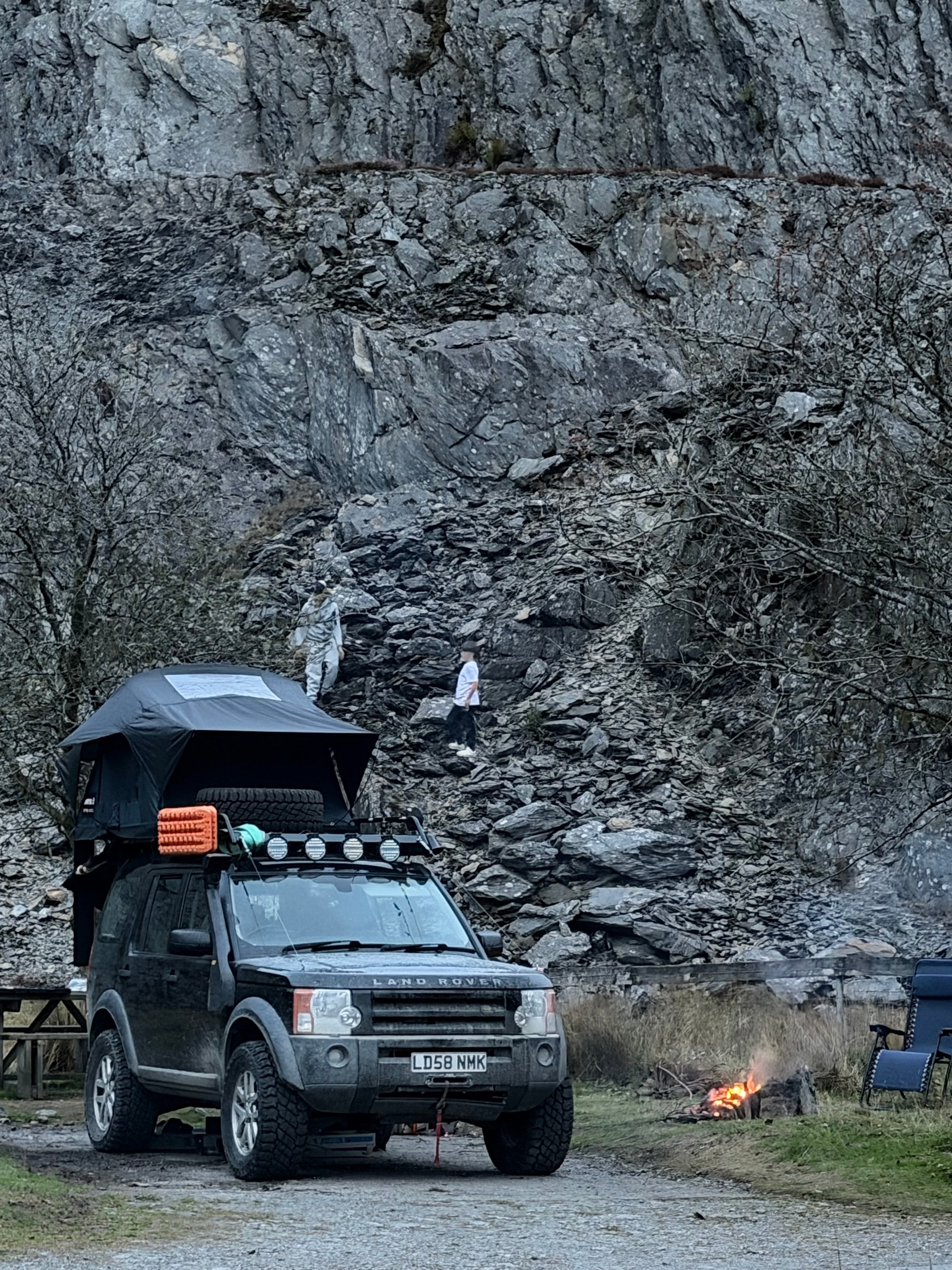 Land Rover with roof tent at a rocky Welsh campsite